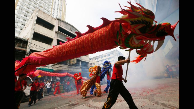 A dragon dances with lions in Manila, Philippines. 