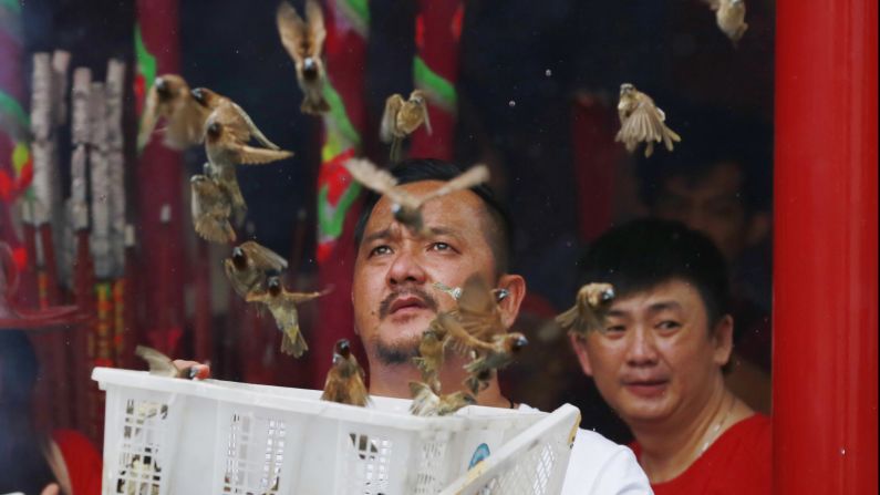 A man releases birds to bring good luck at the Dharma Bakti Temple in Jakarta, Indonesia.
