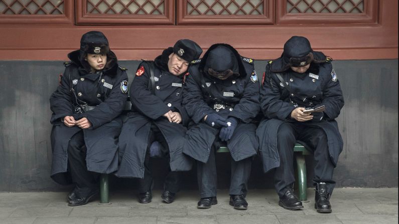 Security guards take a break on the first day of the Lunar New Year at the Yonghe Temple in Beijing.