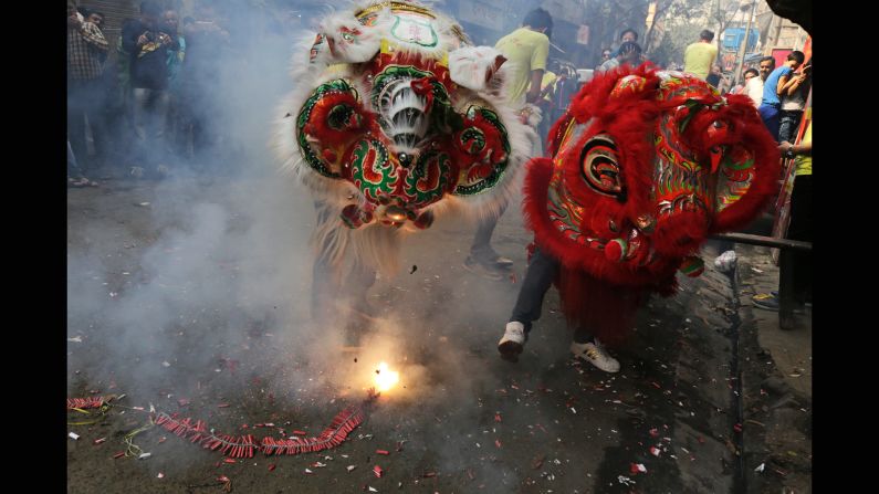 Loud noises are said to drive away evil spirits, but not these lion dancers at a Chinese settlement in Kolkata, India.