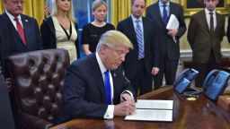 President Donald Trump signs an executive memorandum on defeating the Islamic State in Iraq and Syria after signing it in the Oval Office of the White House on January 28, 2017, in Washington, DC. 