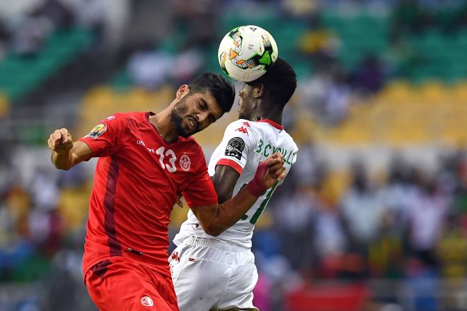 Tunisia's Ferjani Sassi (L) and Cyrille Bayala of Burkina Faso tussle in the air in what was a tense quarterfinal.  