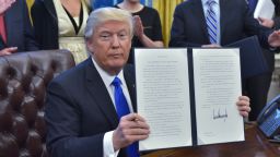 President Donald Trump holds an executive memorandum on defeating the Islamic State in Iraq and Syria after signing it in the Oval Office of the White House on January 28, 2017, in Washington, DC.