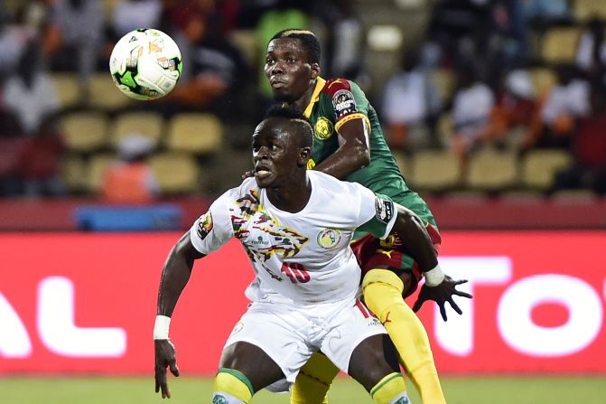 Cameroon defender Ambroise Oyongo challenges Senegal's Sadio Mane -- the Liverpool winger who would later miss a crucial penalty.