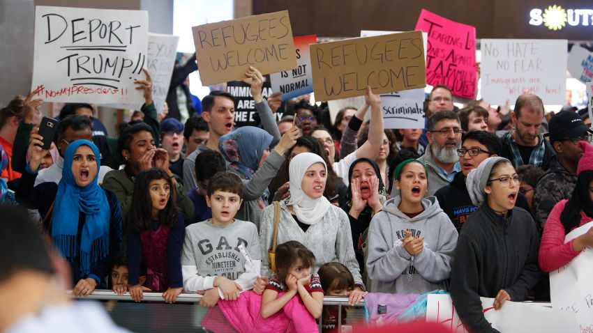 DALLAS, TX - JANUARY 28: Protesters gather to denounce President Donald Trump's executive order that bans certain immigration, at Dallas-Fort Worth International Airport on January 28, 2017 in Dallas, Texas. President Trump signed the controversial executive order that halted refugees and residents from predominantly Muslim countries from entering the United States. (Photo by G. Morty Ortega/Getty Images)