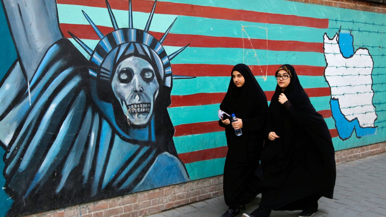 Iranian women walk past the former US embassy in Tehran in November 2016 during a demonstration marking the anniversary of the 1979 hostage crisis.