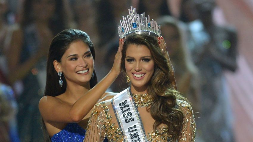Miss Universe contestant Iris Mittenaere of France is crowned the new  winner by former Miss Universe Pia Wurtzbach of the Philippines.