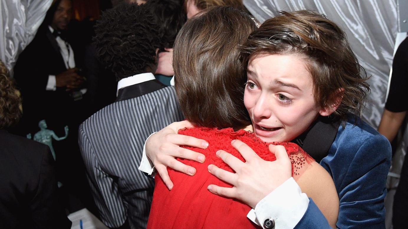 Noah Schnapp, right, hugs Millie Bobby Brown backstage at the Screen Actors Guild Awards on Sunday, January 29. The "Stranger Things" cast won the award for Outstanding Ensemble in a Drama Series.