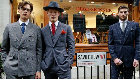 LONDON, ENGLAND - OCTOBER 05: Models pose as Bowmont Merino and Exmoor Horn sheep graze the length of Savile Row to mark the launch of Wool Week 2015 with 'Sheep on the Row' on October 5, 2015 in London, England. (Photo by Tristan Fewings/Getty Images for The Campaign for Wool)
