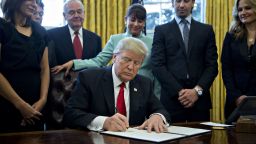 U.S. President Donald Trump signs an executive order in the Oval Office of the White House January 30, 2017 in Washington, DC. Trump said he will "dramatically" reduce small business regulations overall with this executive action. (Photo by Andrew Harrer - Pool/Getty Images)