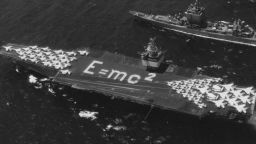 Aerial view of the world's first nuclear-powered aircraft carrier the USS Enterprise (CVN-65) of the United States Navy, with physicist Albert Einstein's E = mc 2 mass--energy equivalence equation laid out on the flight deck, is escorted by the missile cruiser USS Long Beach (centre) and the missile frigate, USS Bainbridge, during Operation Sea Orbit, the first circumnavigation of the world by nuclear-powered surface warships,31 July 1964 off Bahia de Pollença, Mallorca, Spain.  (Photo by Keystone/Getty Images)