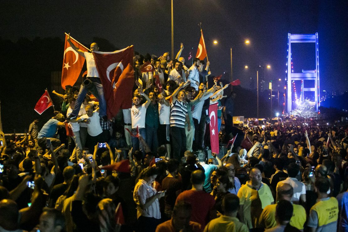 Turks take to the streets near the Fatih Sultan Mehmet bridge, which crosses the Bosphorus, in the early morning hours after a July, 15, 2016 coup attempt.