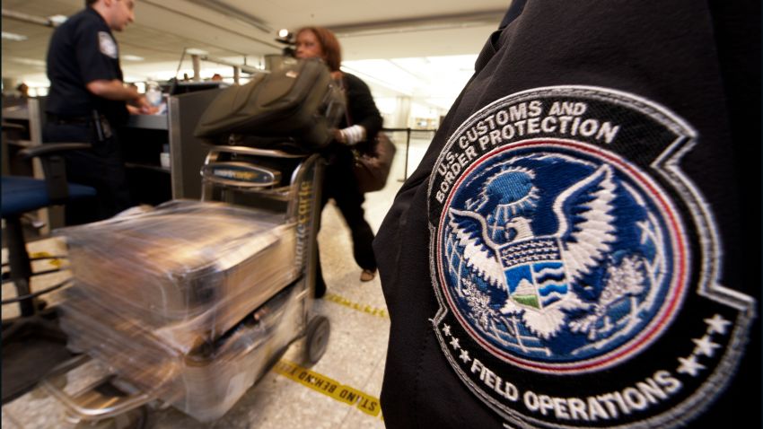 An international air traveler is cleared by a US Customs and Border Protection Officer (L) and is approved to enter the United States inside the US Customs and Immigration area at Dulles International Airport (IAD) , December 21, 2011 in Sterling, Virgina, near Washington, DC.     AFP Photo/Paul J. Richards (Photo credit should read PAUL J. RICHARDS/AFP/Getty Images)