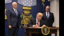 US President Donald Trump signs an executive order alongside US Defense Secretary James Mattis and US Vice President Muike Pence on January 27, 2017, at the Pentagon in Washington, DC.Trump signed an order Friday to begin what he called a "great rebuilding" of the US armed services, promising new aircraft, naval ships and more resources for the military. "Our military strength will be questioned by no one, but neither will our dedication to peace. We do want peace," Trump said in a ceremony at the Pentagon. / AFP / MANDEL NGAN        (Photo credit should read MANDEL NGAN/AFP/Getty Images)