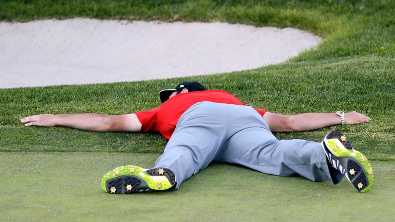 PGA Tour golfer Jon Rahm lies on the 18th green after winning the Farmers Insurance Open in San Diego on Sunday, January 29. It was his first victory on tour.