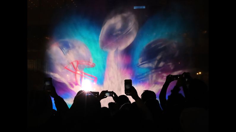 People take photos of a 3-D light show projected onto water spray in Houston on Sunday, January 29. Houston is hosting the Super Bowl on February 5. <a href="index.php?page=&url=http%3A%2F%2Fwww.cnn.com%2F2017%2F01%2F24%2Fsport%2Fgallery%2Fwhat-a-shot-sports-0124%2Findex.html" target="_blank">See 23 amazing sports photos from last week</a>
