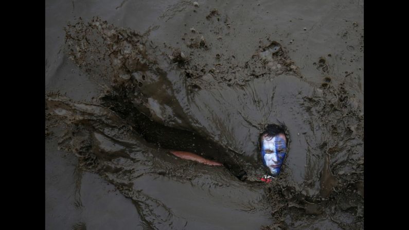 A competitor falls in mud during a Tough Guy event in Perton, England, on Sunday, January 29. The annual charity race includes a cross-country run and various obstacles.