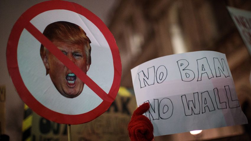LONDON, ENGLAND - JANUARY 30: Demonstrators hold up placards during a protest outside Downing Street against U.S. President Donald Trump's ban on travel from seven Muslim countries on January 30, 2017 in London, England. President Trump signed an executive order on Friday banning immigration to the USA from seven Muslim countries. This led to protests across America and, today, in the UK, a British petition asking for the downgrading of Trump's State visit passed one million signatures this morning. (Photo by Jack Taylor/Getty Images)
