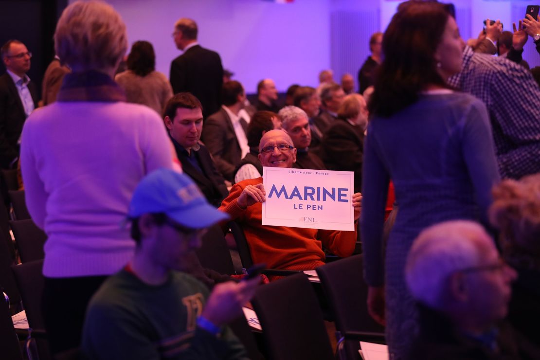 A man holds a Marine Le Pen placard at a conference of European populist, right-wing parties in Koblenz, Germany. 