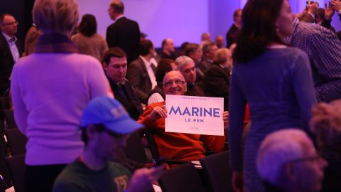 A man holds a Marine Le Pen placard at a conference of European populist, right-wing parties in Koblenz, Germany. 