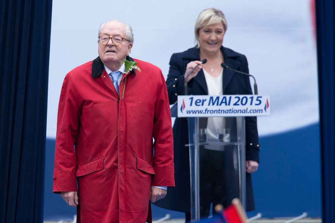 National Front founder Jean-Marie Le Pen stands in front of his daughter Marine Le Pen, president of the party.