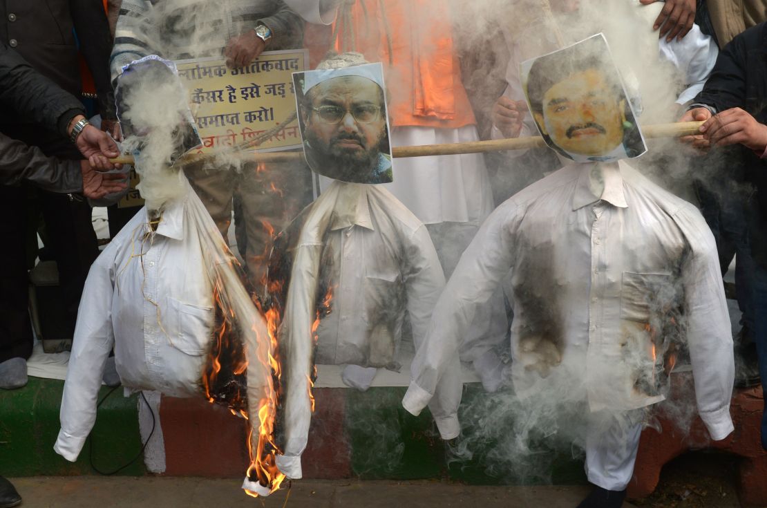Activists burn an effigy of Hafiz Saeed during a protest in New Delhi on December 21, 2014.  