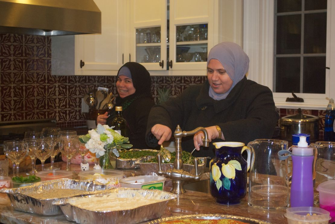 Maryam and Fatimah prepare food in the kitchen before guests arrive.