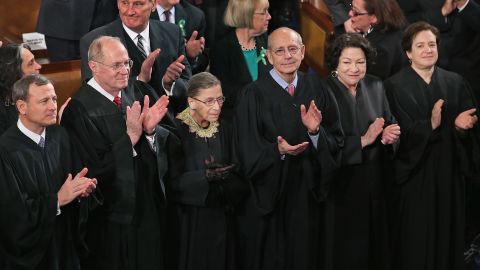 Members of the Supreme Court, (L-R) Chief Justice John Roberts and associate justices Anthony Kennendy, Ruth Bader Ginsburg, John Paul Stevens, Sonia Sotomayor and Elena Kagan, applaud as former President Barack Obama arrives to deliver his State of the Union speech before a joint session of Congress at the U.S. Capitol February 12, 2013 in Washington.