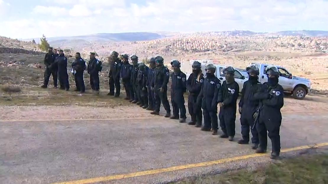 A line of Israeli security forces prevent further right wing protesters from entering the Amona settlement.