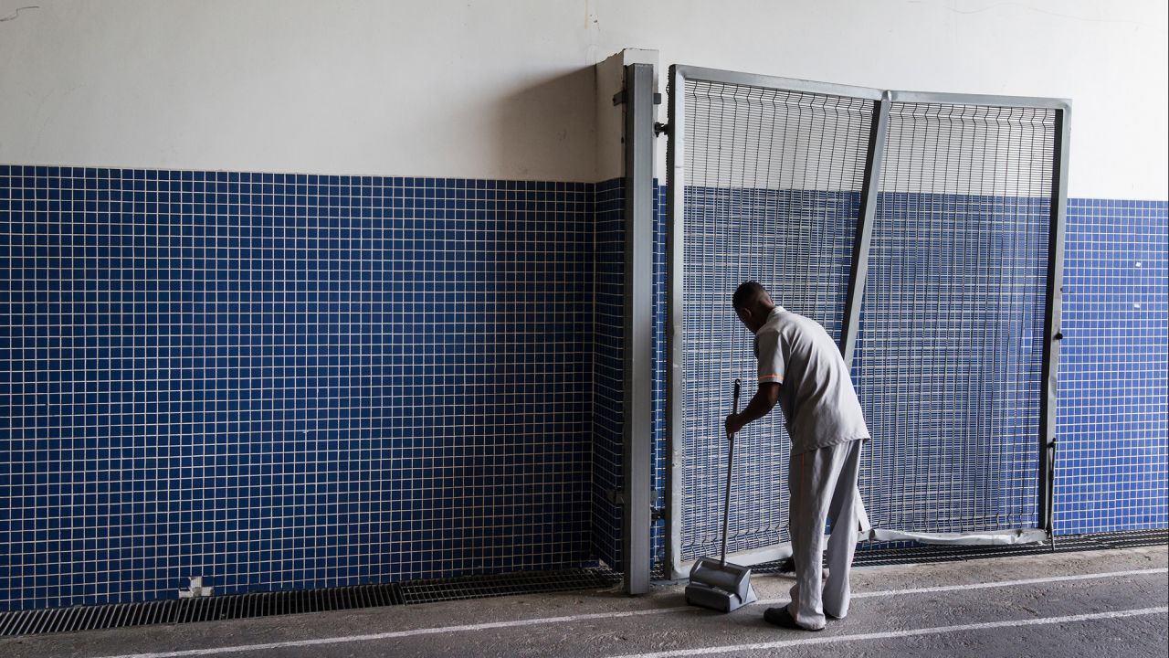 A man cleans one of the entrances to the stadium.