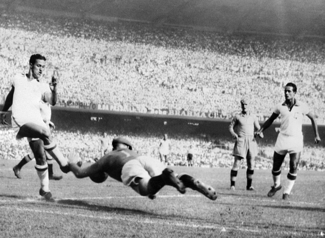 Swedish goalkeeper Kalle Svensson dives to block the ball in front of Brazilian forward Ademir 09 July 1950 during their World Cup final pool match.