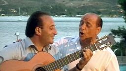 Berlusconi sings with Italian performer Mariano Apicella during a party in 2003.