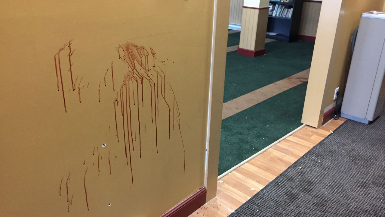 A wall at the Quebec Islamic Cultural Center, where six people were killed Sunday, is stained with blood and dotted with bullet holes.