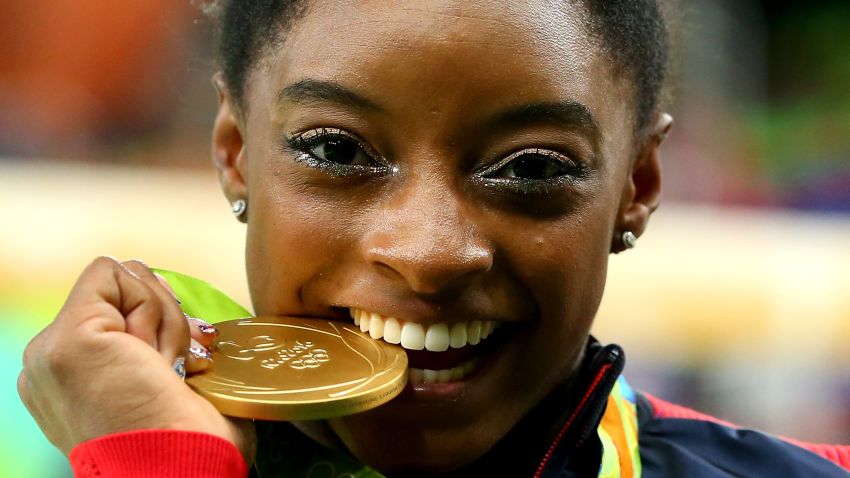 RIO DE JANEIRO, BRAZIL - AUGUST 11:  Gold medalist Simone Biles of the United States poses for photographs after the medal ceremony for the Women's Individual All Around on Day 6 of the 2016 Rio Olympics at Rio Olympic Arena on August 11, 2016 in Rio de Janeiro, Brazil.  (Photo by Alex Livesey/Getty Images)