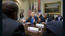 President Donald Trump holds an African American History Month listening session attended by nominee to lead the Department of Housing and Urban Development (HUD) Ben Carson (R), Director of Communications for the Office of Public Liaison Omarosa Manigault (L) and other officials in the Roosevelt Room of the White House on February 1, 2017 in Washington, DC.