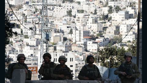 Israeli soldiers stand guard blocking an entrance to the Jewish settlers zone of Hebron's Tel Rumeida neighbourhood, on September 18, 2016.