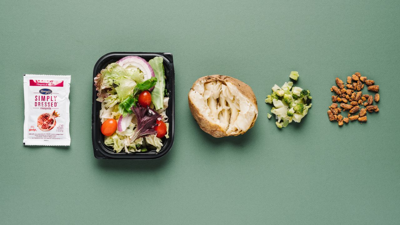Even without cheese, a baked potato with broccoli at Wendy's delivers 9 grams of fiber and 10 grams of protein. Pair the potato with a garden side salad with pomegranate dressing, and add roasted pecans to boost the protein of the meal. 