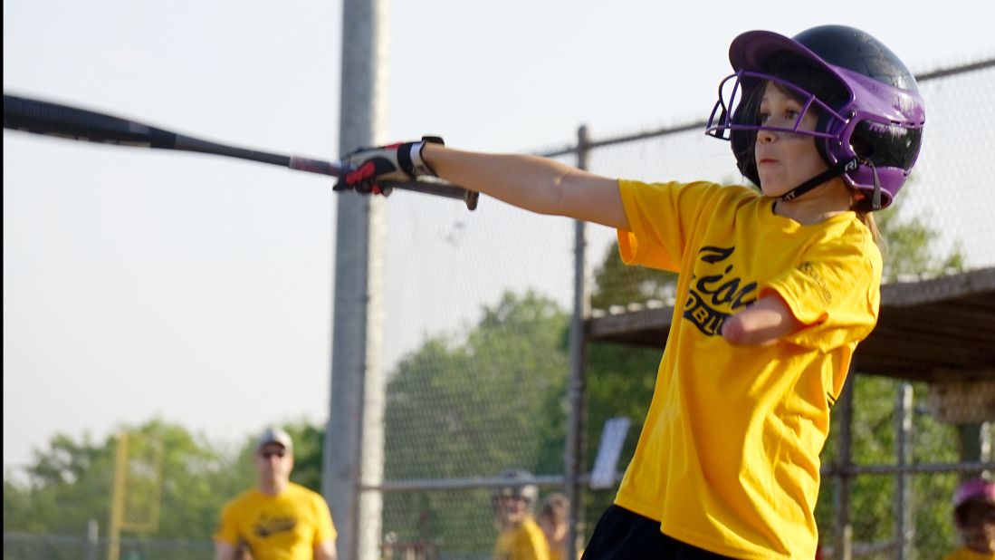 Jordan is an athlete; she's shown here taking a swing on the baseball field.