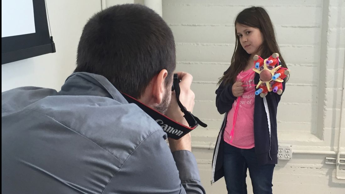 Jordan shows off her glitter-shooting prosthetic arm she made a the Superhero Cyborg camp in January 2016.