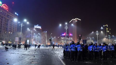 Police and demonstrators face off February 1 in Bucharest. Some people threw flares and other objects at security forces.
