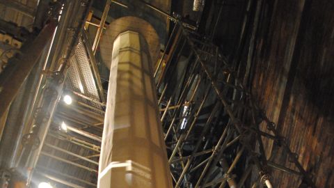 One of two wrapped spools containing the painting. A crane will lift both spools through the roof.