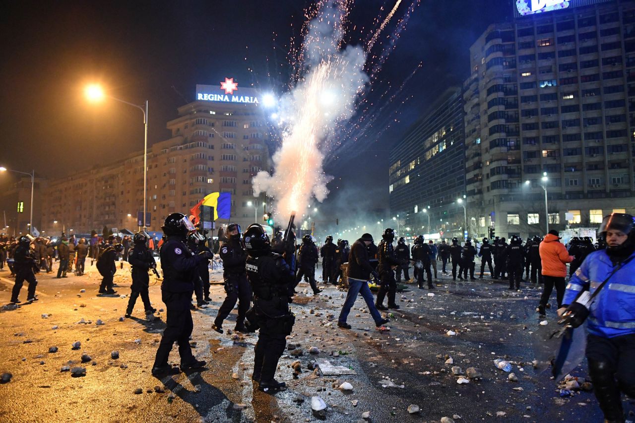 Riot police try to disperse demonstrators with tear gas February 1 in Bucharest. If it had gone into effect, the new law would have stopped ongoing investigations for corruption offenses and would prevent the launching of any subsequent probes.