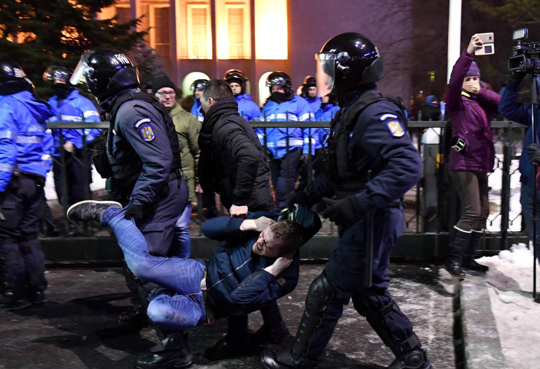 Romanian anti-riot police evacuate a protester during the anti-amnesty demonstrations in Bucharest.