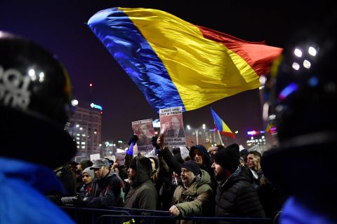 People wave flags in opposition to the government's decree February 1 in Bucharest. The embassies of Belgium, Canada, France, Germany, the Netherlands and the United States issued a joint statement expressing concern over the Romanian government's actions. The European Commission president also voiced worry.