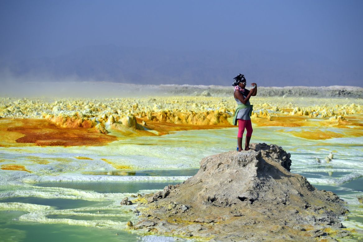 A tourist takes photos of the landscape. Despite the brutal conditions, Danakil is becoming an increasingly popular holiday destination. <br />