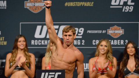 Urijah Faber stands on the scale during the weigh-in for a UFC tournament last year.