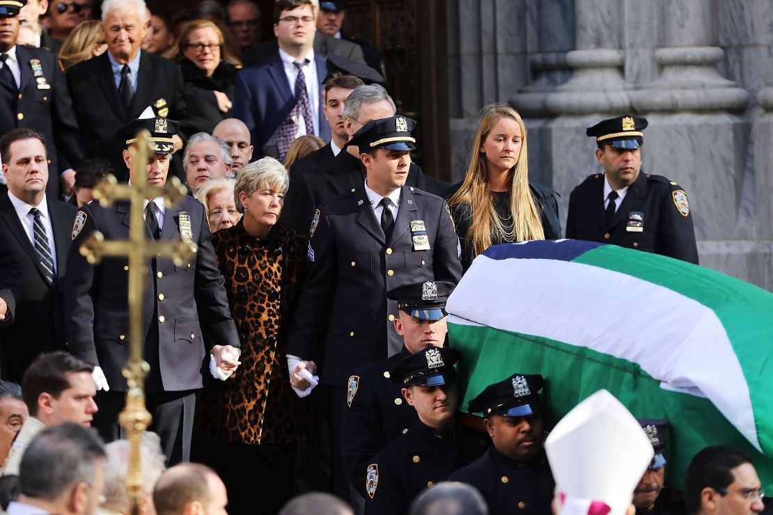 Patti Ann McDonald and son Conor follow Steven McDonald's casket at his funeral last month. 