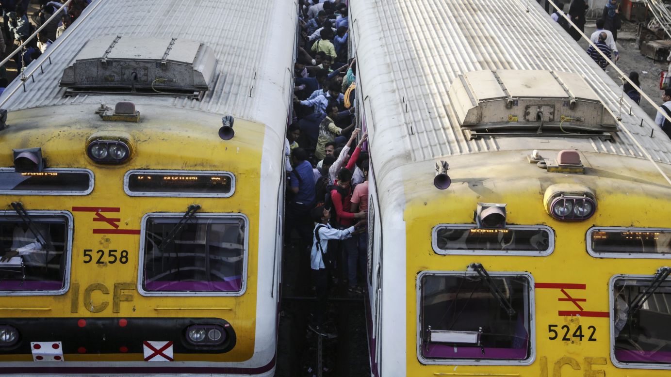 Commuters board a train in Mumbai, India, on Wednesday, February 1.