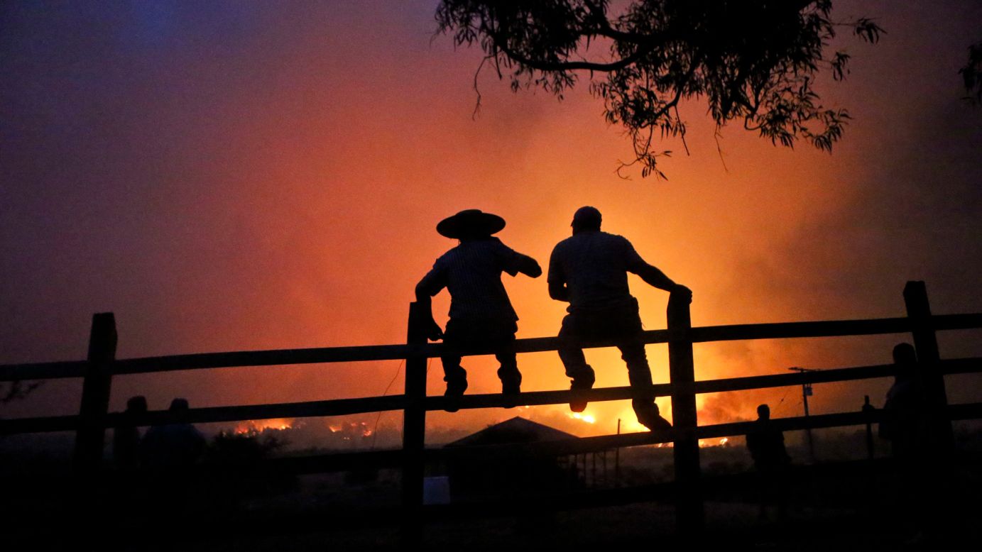 Residents watch a forest burn in Portezuelo, Chile, on Sunday, January 29. <a href="http://www.cnn.com/2017/01/27/americas/chile-wildfires/" target="_blank">A chain of wildfires has unleashed a catastrophe in central and southern Chile</a>, killing at least 11 people, destroying thousands of homes and consuming an area about three times the size of New York City, authorities said. President Michelle Bachelet has announced that the country will continue with its various measures to deal with wild fires. "We have never seen anything on this scale, never in the history of Chile," Bachelet, who has declared a state of emergency, said earlier this week.