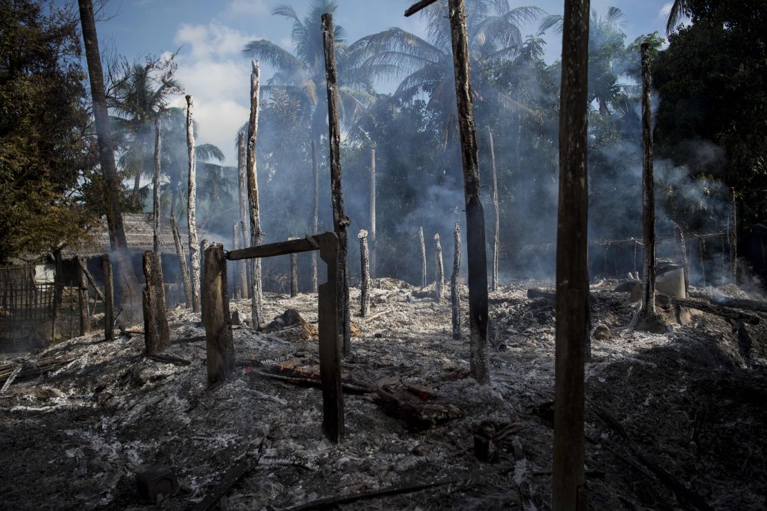 Smouldering debris of burned houses is seen in a village in Myanmar's Rakhine state.